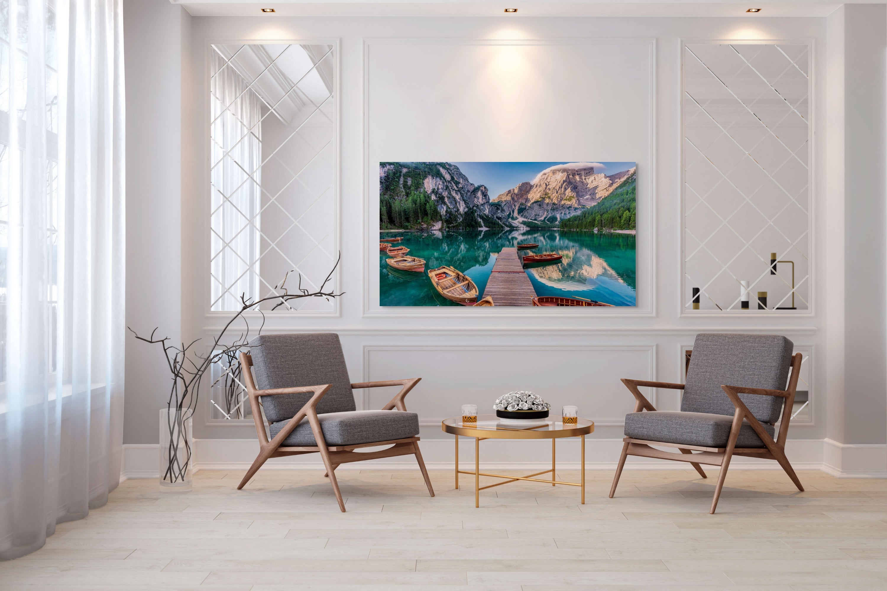 Living room with two gray chairs, a coffee table, and a large wall-mounted fine art print of Braies Lake.